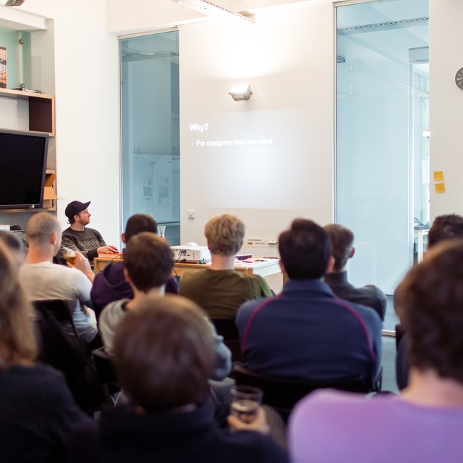 persons in a meet watching a presentation